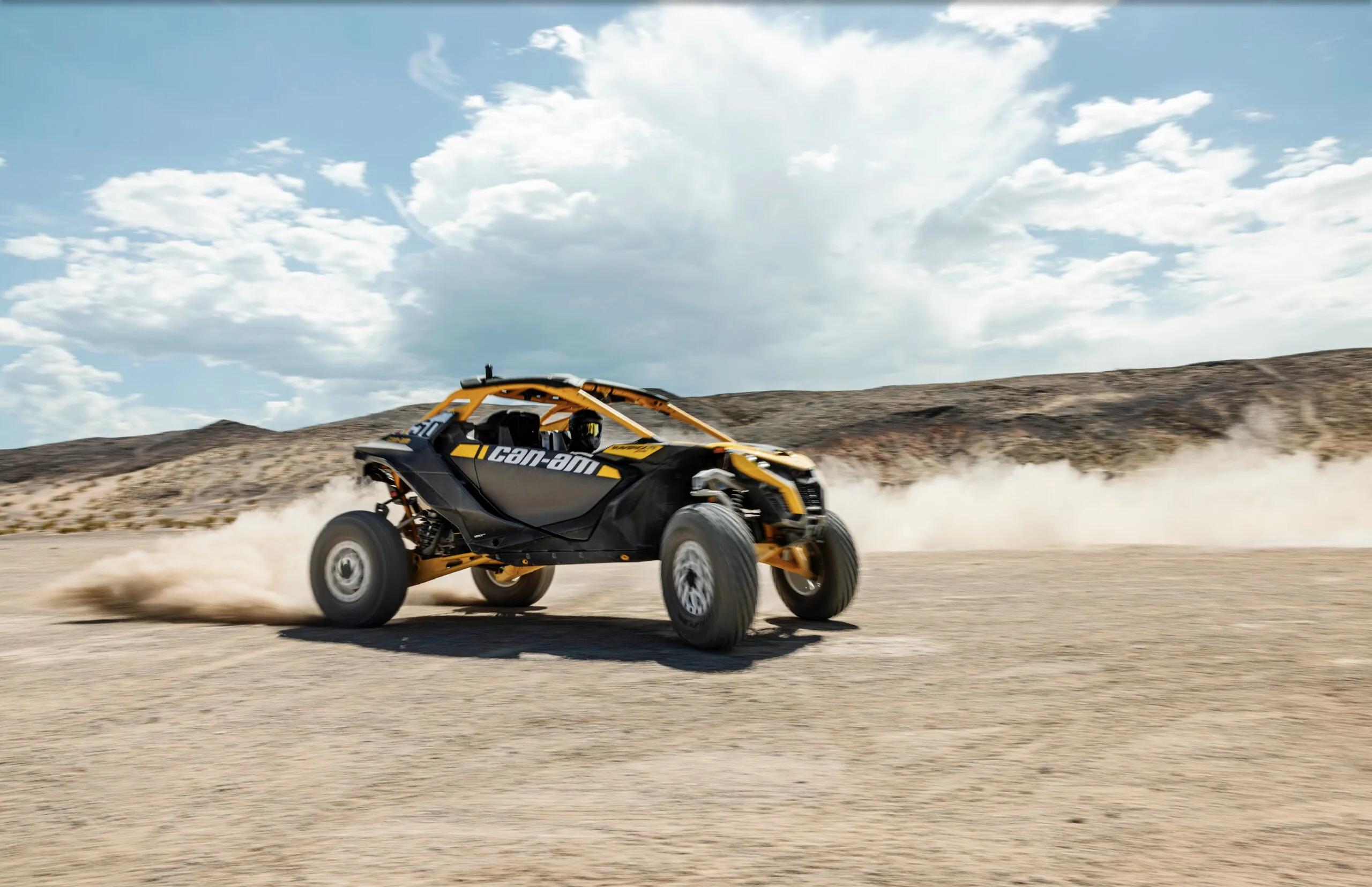 Can-Am Maverick R turbo dune buggy powering across the Dubai desert