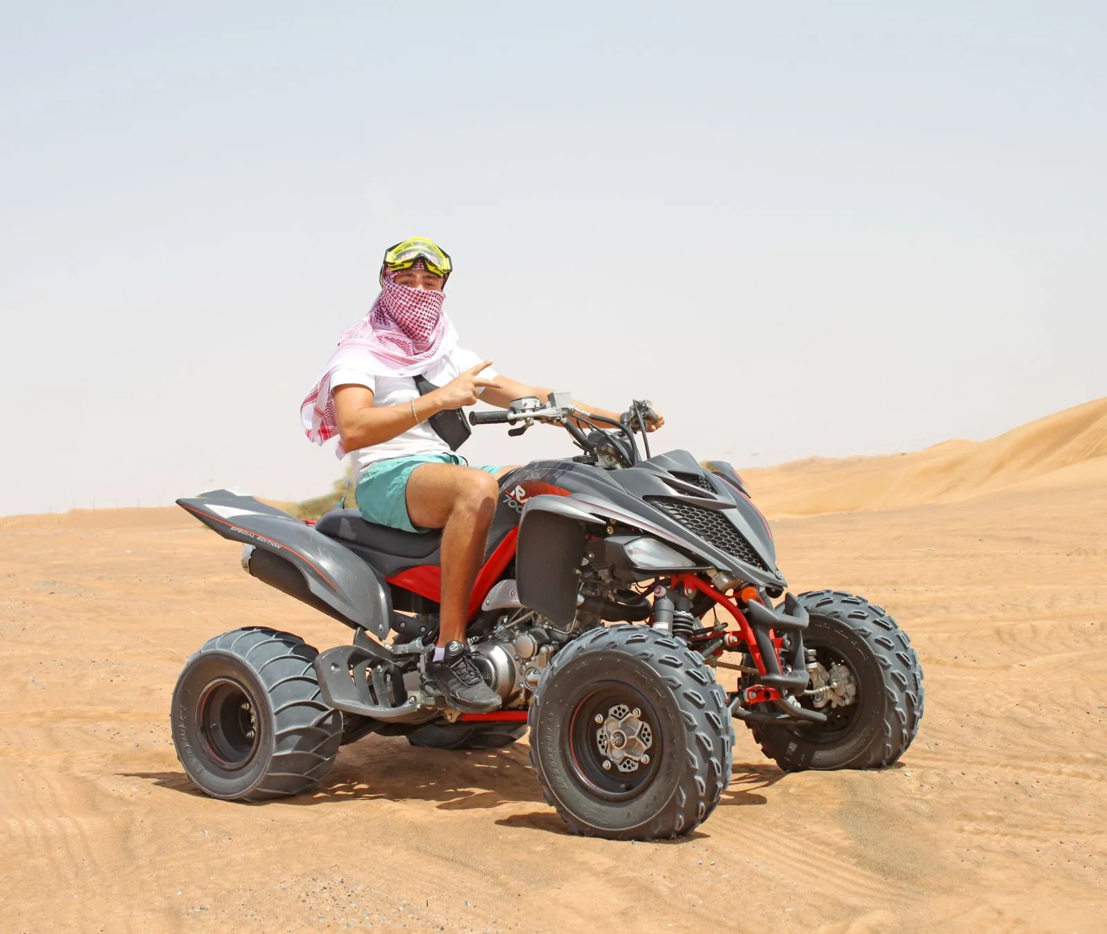 Rider on a Yamaha Raptor 700 sport quad in the Dubai desert