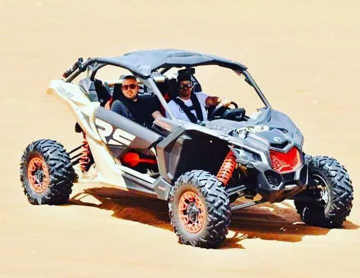 Family riding a Can-Am Maverick X3 4-seater dune buggy in Dubai