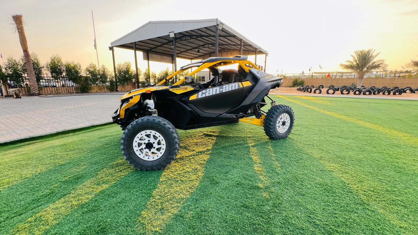 Yellow Can-Am Maverick R dune buggy parked at the Buggy Rents base in Al Awir