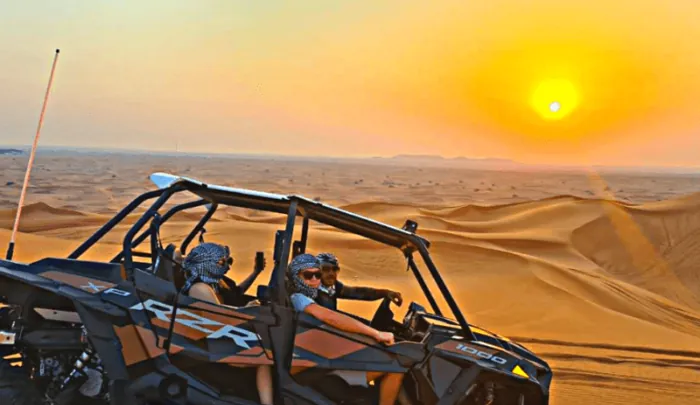 Dune buggy on the sand at sunrise before a guided Dubai desert tour