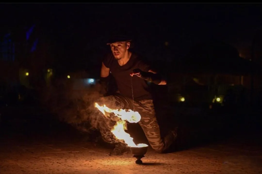 Fire show performer entertaining guests at a Dubai desert safari camp