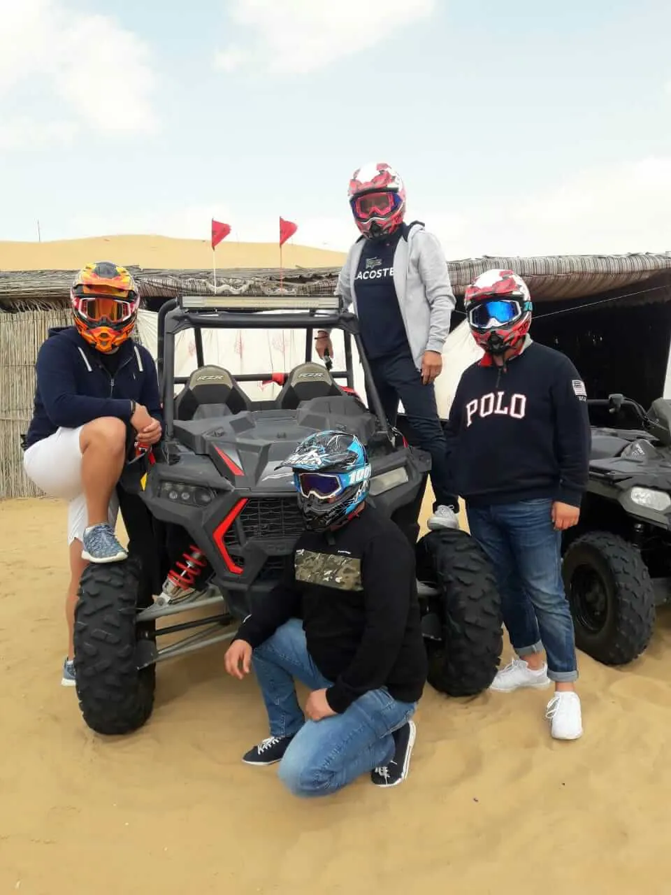Group of guests with a Polaris dune buggy on a Dubai desert photo stop