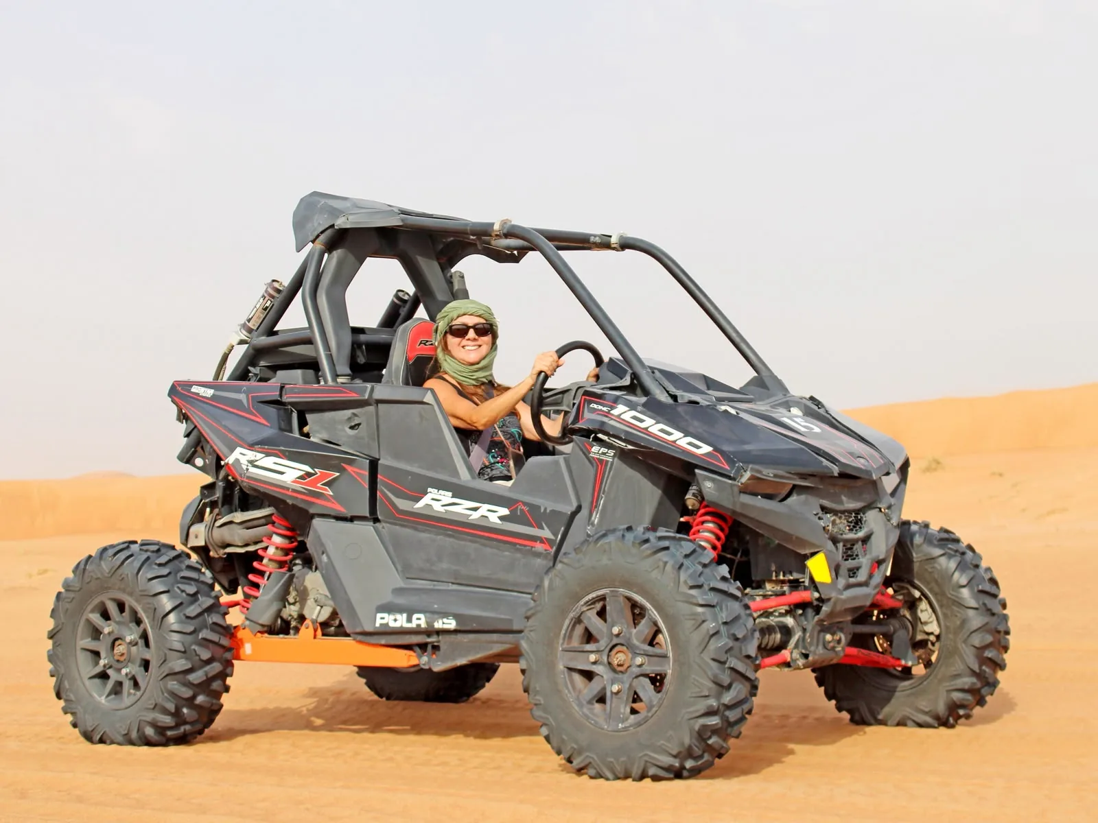 Solo driver in a Polaris RZR 1000 dune buggy on the Dubai red dunes