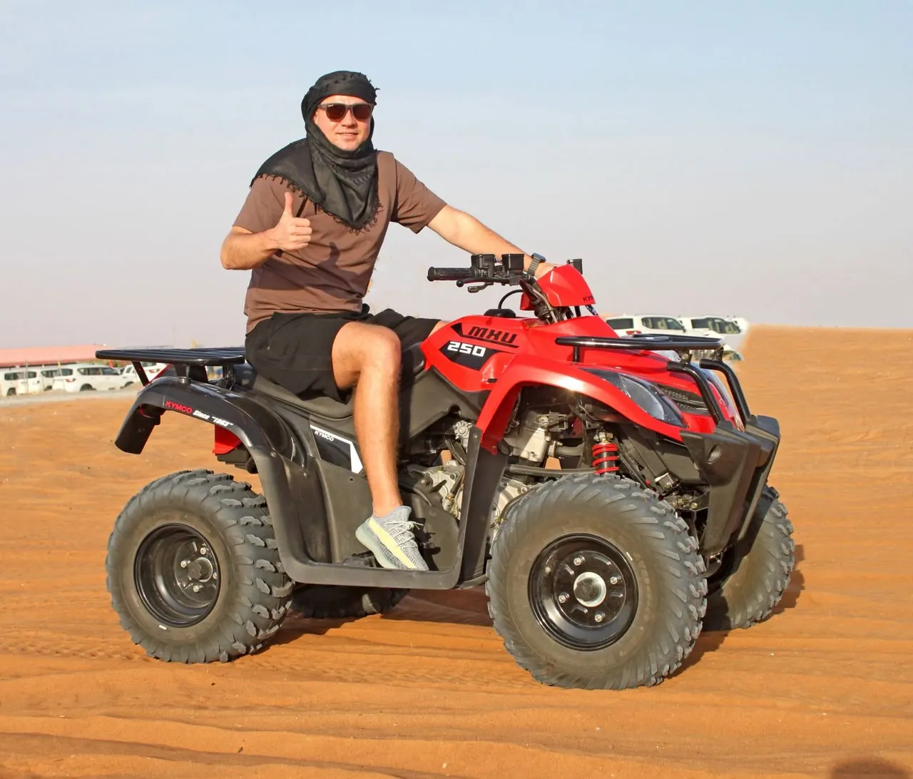 Rider on a red quad bike during a Dubai desert quad biking session
