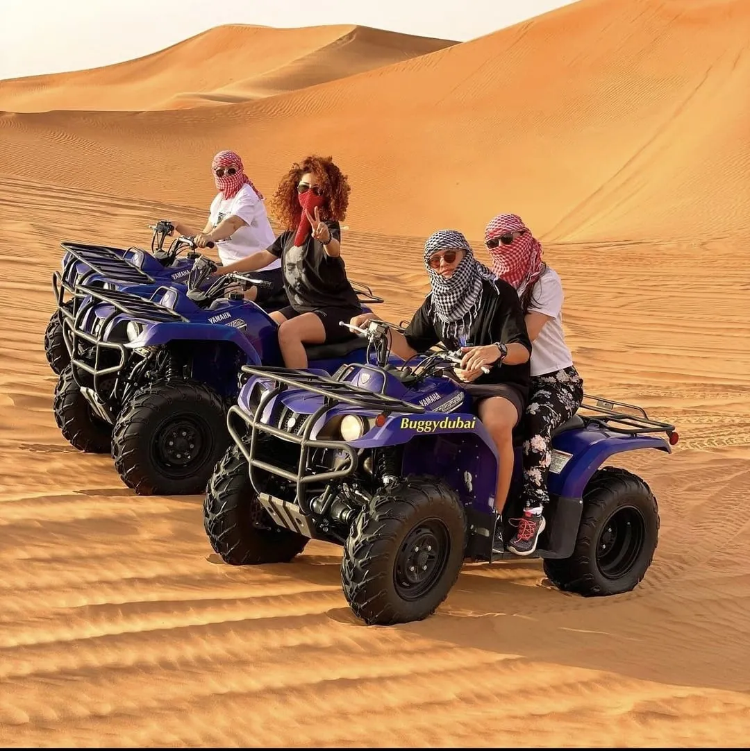 Group of women on quad bikes during a Dubai desert quad biking tour