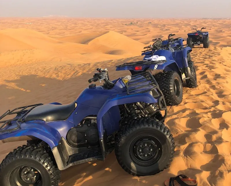 Two seater quad bikes lined up for a desert ride in Dubai