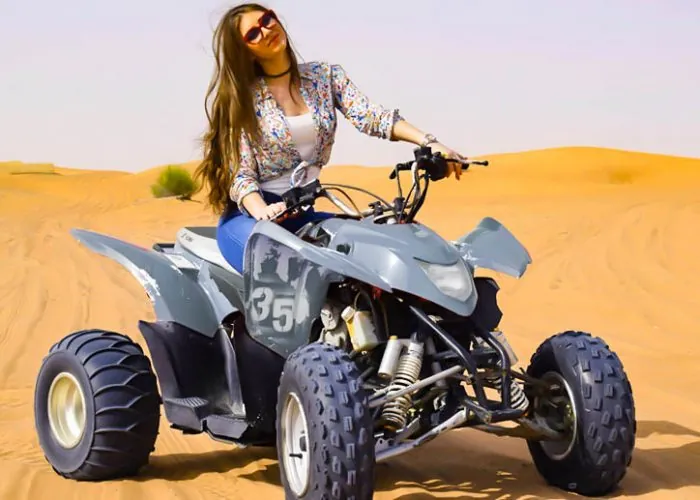 Rider on a Yamaha Raptor quad bike on a Dubai desert dune