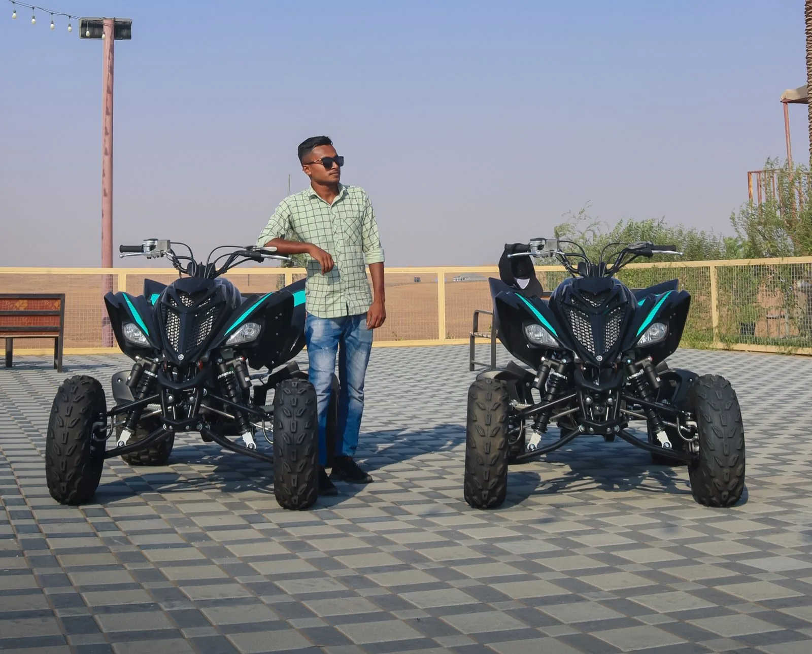 Two Yamaha Raptor quad bikes parked at the Buggy Rents base in Al Awir, Dubai